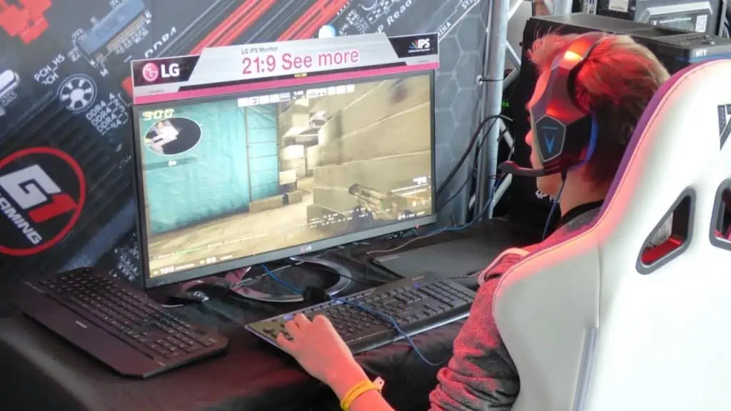 Een pc-gamer met headset voor zijn monitor